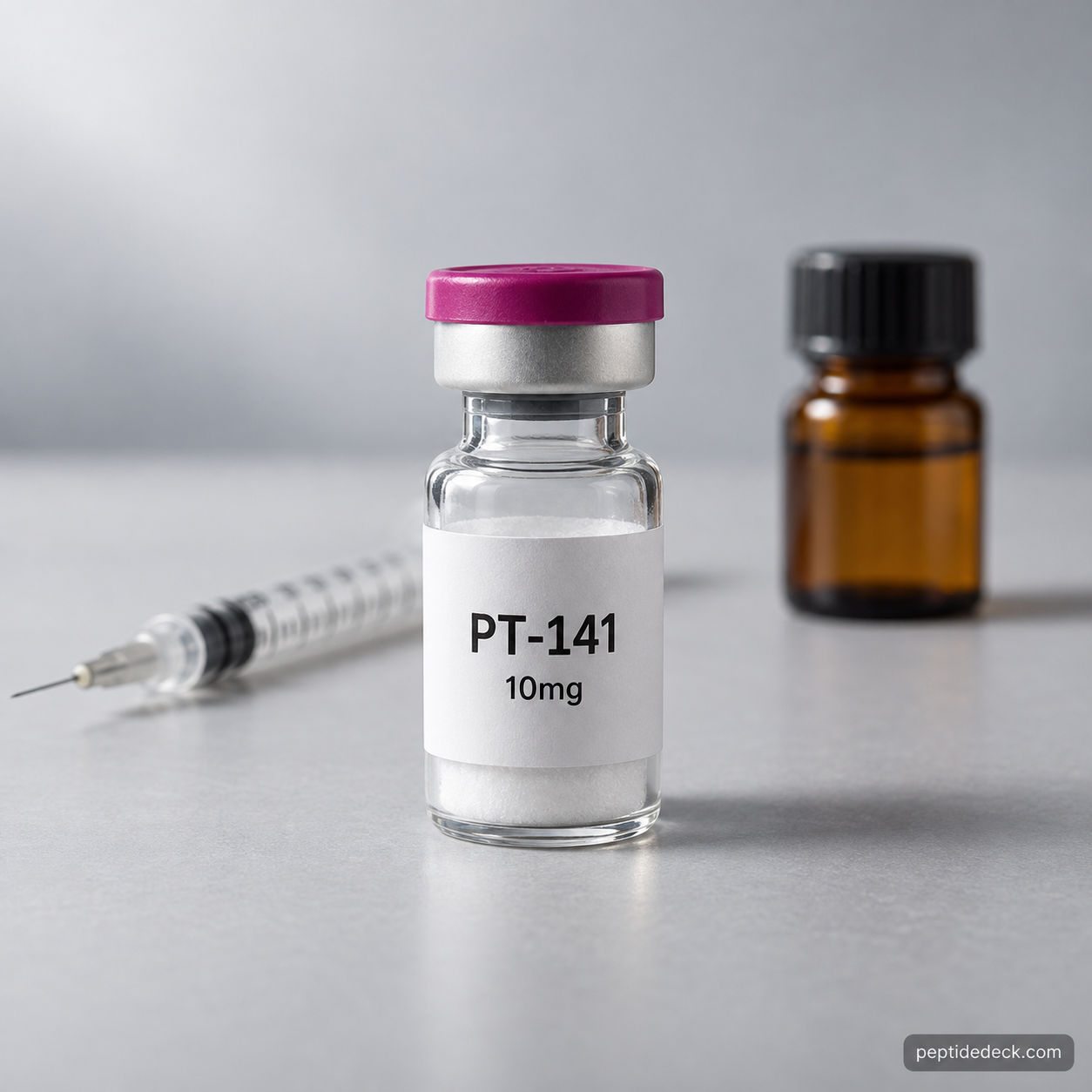 A 10mg PT-141 peptide vial with a magenta cap beside an insulin syringe and a bottle of bacteriostatic water on a grey surface